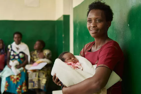Mother waiting with infant in clinic Africa